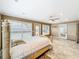 Large main bedroom features tile flooring, neutral paint, ceiling fan and natural light at 5452 Higgins Way, Orlando, FL 32808