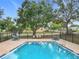 Inviting community pool area with sparkling water, multiple seating options, and shaded spots for relaxation at 5452 Higgins Way, Orlando, FL 32808