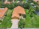Aerial view of a well-maintained home with a tile roof, lush lawn, and brick driveway at 572 Sienna Dr, Poinciana, FL 34759