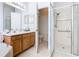 Bright bathroom showcasing a glass-enclosed shower, double sinks, and modern fixtures at 572 Sienna Dr, Poinciana, FL 34759