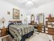 Inviting bedroom featuring a decorative bed, mirrored furniture, and ample natural light at 572 Sienna Dr, Poinciana, FL 34759