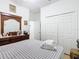 Comfortable bedroom with a dresser, ample storage, and a view into the hallway and bathroom at 572 Sienna Dr, Poinciana, FL 34759