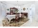 Elegant dining room with decorative rug, and a china cabinet, offering a perfect space for formal gatherings at 572 Sienna Dr, Poinciana, FL 34759