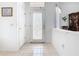 Bright entryway featuring tiled floors, decorative glass door, and fresh white walls perfect for welcoming guests at 572 Sienna Dr, Poinciana, FL 34759