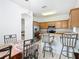 Open kitchen and dining area with stainless steel appliances, breakfast bar, and seamless flow for entertaining at 572 Sienna Dr, Poinciana, FL 34759