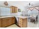 Well-maintained kitchen featuring stainless steel appliances, white tile floors, and a sink overlooking the dining area at 572 Sienna Dr, Poinciana, FL 34759