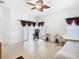 Living room featuring tile floors, ceiling fan, and natural light creates a comfortable and inviting space at 572 Sienna Dr, Poinciana, FL 34759