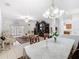 Open-concept living space with a dining area, and living room featuring tile floors and ample natural light at 572 Sienna Dr, Poinciana, FL 34759