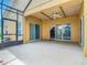 Open-air patio with sliding glass doors, ceiling fan, and views of the backyard and mature landscaping at 572 Sienna Dr, Poinciana, FL 34759