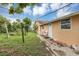 Side view of the backyard of home with trees and grass at 600 Regency Way, Kissimmee, FL 34758