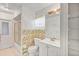 A neutral-colored bathroom with a large mirror and tiled walls at 600 Regency Way, Kissimmee, FL 34758