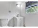 Bathroom with white vanity and sink and window at 600 Regency Way, Kissimmee, FL 34758