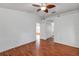 Bedroom with a ceiling fan, wood-look flooring, closet, and attached bathroom at 600 Regency Way, Kissimmee, FL 34758
