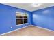 The bedroom has a window and laminate flooring at 600 Regency Way, Kissimmee, FL 34758