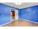 Bedroom with laminate flooring and an open doorway to the hall at 600 Regency Way, Kissimmee, FL 34758