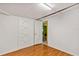 Bedroom with hardwood floors, closet, and white walls at 600 Regency Way, Kissimmee, FL 34758
