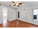 Bedroom with wood-look floors, ceiling fan, and two windows letting in natural light at 600 Regency Way, Kissimmee, FL 34758