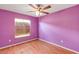 Bedroom with laminate floors, ceiling fan, and a boarded window at 600 Regency Way, Kissimmee, FL 34758