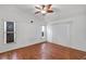 Bright bedroom featuring wood-look floors, ceiling fan, and lots of natural light at 600 Regency Way, Kissimmee, FL 34758