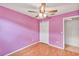 This bedroom features hardwood floors and a ceiling fan at 600 Regency Way, Kissimmee, FL 34758