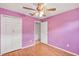 Bedroom with ceiling fan, closet, and laminate floors at 600 Regency Way, Kissimmee, FL 34758