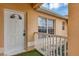 Front entryway with white door and railing leading up to the front entrance at 600 Regency Way, Kissimmee, FL 34758