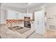 Bright kitchen with tile floor, double sink, white cabinets, stainless appliances, and tiled backsplash at 600 Regency Way, Kissimmee, FL 34758