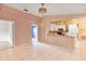 Spacious eat-in kitchen featuring tile floors, white cabinets, and breakfast bar at 600 Regency Way, Kissimmee, FL 34758