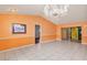 Open living area with tile flooring and a chandelier light fixture above at 600 Regency Way, Kissimmee, FL 34758