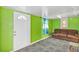 Living room with green walls and colorful patterned carpet at 600 Regency Way, Kissimmee, FL 34758