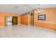 Open living area with tile flooring and a chandelier light fixture above at 600 Regency Way, Kissimmee, FL 34758