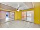Open-concept living room with tiled floors, sliding glass doors, and bright walls at 600 Regency Way, Kissimmee, FL 34758
