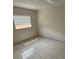A bedroom with neutral wall paint, tile flooring and a window with blinds at 702 Michigan Ct # 4, St Cloud, FL 34769