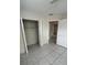 Bedroom with open closet and tiled floors at 702 Michigan Ct # 4, St Cloud, FL 34769