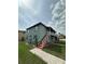 Two-story apartment building with exterior stairs, balcony, and tidy landscaping at 702 Michigan Ct # 4, St Cloud, FL 34769