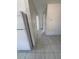 Tiled hallway adjacent to the kitchen, offering access to other areas of the apartment at 702 Michigan Ct # 4, St Cloud, FL 34769
