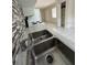 Close up on the kitchen sink with modern faucet and backsplash, and visible appliances at 702 Michigan Ct # 4, St Cloud, FL 34769