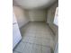 Spacious living room featuring tiled flooring, natural light, and neutral paint at 702 Michigan Ct # 4, St Cloud, FL 34769