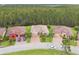 Aerial view showcasing a well-maintained home with beautiful landscaping in a tree-filled community at 726 Irvine Ranch Rd, Kissimmee, FL 34759