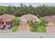 An aerial shot reveals a charming home featuring a long driveway and mature trees in a lovely neighborhood at 726 Irvine Ranch Rd, Kissimmee, FL 34759