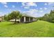 Beautiful backyard features green lawn and mature landscaping, creating a peaceful outdoor space at 726 Irvine Ranch Rd, Kissimmee, FL 34759