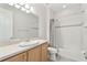 This bathroom features a tub, toilet, vanity, and large mirror at 726 Irvine Ranch Rd, Kissimmee, FL 34759