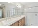 Bright bathroom featuring a glass shower, double vanity, and modern fixtures at 726 Irvine Ranch Rd, Kissimmee, FL 34759