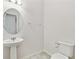 This powder room features a pedestal sink, toilet, and ceramic tile floor at 726 Irvine Ranch Rd, Kissimmee, FL 34759