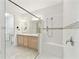 Bathroom with a tiled glass shower, double vanity, and ample lighting at 726 Irvine Ranch Rd, Kissimmee, FL 34759