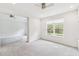 Bright bedroom features neutral carpet, ceiling fan, and large window at 726 Irvine Ranch Rd, Kissimmee, FL 34759