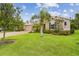 Well-manicured front yard with lush green grass and a mature palm tree in front of the home at 726 Irvine Ranch Rd, Kissimmee, FL 34759