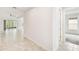 View of the hallway with ceramic floors leading to the living areas and bedroom at 726 Irvine Ranch Rd, Kissimmee, FL 34759