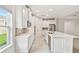 Bright kitchen with white cabinetry, stainless steel appliances, tile backsplash, and an island with counter seating at 726 Irvine Ranch Rd, Kissimmee, FL 34759