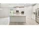 Modern kitchen with white cabinets, stainless steel appliances, a tile backsplash, and a center island at 726 Irvine Ranch Rd, Kissimmee, FL 34759